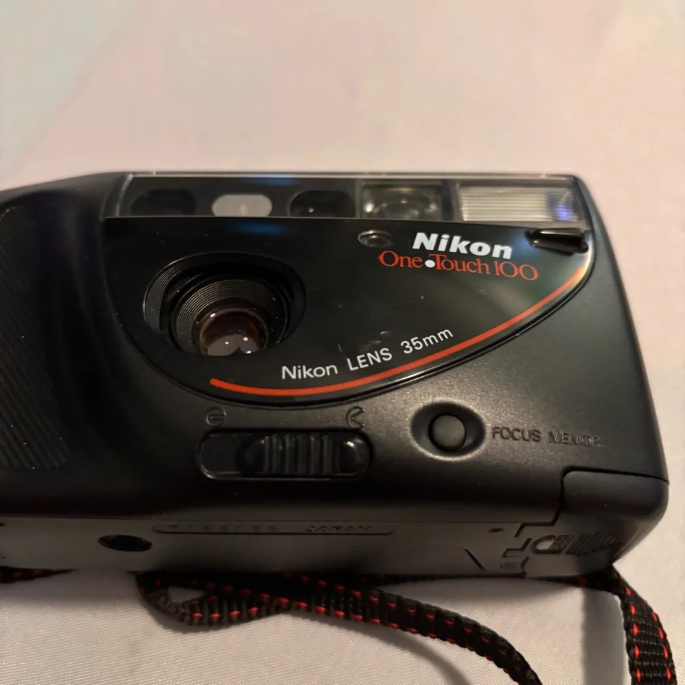 Nikon Black Camera with Red Accents and Case don’t know if it works